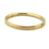 Ballou child’s size 1/20 12K gold filled hinged bangle bracelet with engraved parallel line texture and raised scrolled center
