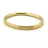 Ballou child’s size 1/20 12K gold filled hinged bangle bracelet with engraved parallel line texture and raised scrolled center