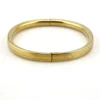Ballou child’s size 1/20 12K gold filled hinged bangle bracelet with engraved parallel line texture and raised scrolled center