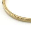Ballou child’s size 1/20 12K gold filled hinged bangle bracelet with engraved parallel line texture and raised scrolled center