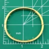 Ballou child’s size 1/20 12K gold filled hinged bangle bracelet with engraved parallel line texture and raised scrolled center