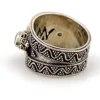 Vintage India sterling silver cigar band ring with three faceted blue flash moonstones and ornate raised silverwork.