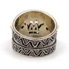 Vintage India sterling silver cigar band ring with three faceted blue flash moonstones and ornate raised silverwork.