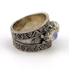 Vintage India sterling silver cigar band ring with three faceted blue flash moonstones and ornate raised silverwork.