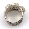 Vintage India sterling silver cigar band ring with three faceted blue flash moonstones and ornate raised silverwork.