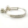 Child’s size sterling silver bangle bracelet with jingling bell charms, crescent moon and star design, marked 925