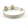 Child’s size sterling silver bangle bracelet with jingling bell charms, crescent moon and star design, marked 925