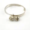 Child’s size sterling silver bangle bracelet with jingling bell charms, crescent moon and star design, marked 925