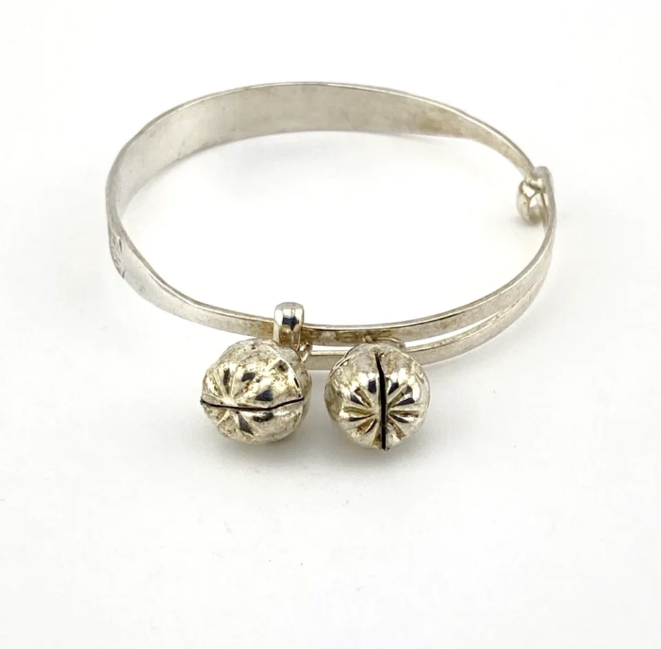 Child’s size sterling silver bangle bracelet with jingling bell charms, crescent moon and star design, marked 925