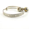 Child’s size sterling silver bangle bracelet with jingling bell charms, crescent moon and star design, marked 925