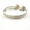 Child’s size sterling silver bangle bracelet with jingling bell charms, crescent moon and star design, marked 925
