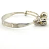 Child’s size sterling silver bangle bracelet with jingling bell charms, crescent moon and star design, marked 925