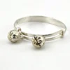 Child’s size sterling silver bangle bracelet with jingling bell charms, crescent moon and star design, marked 925