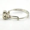 Child’s size sterling silver bangle bracelet with jingling bell charms, crescent moon and star design, marked 925