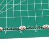Child’s size 1940s sterling silver bracelet with pink guilloché enamel rose stations and squared oval links