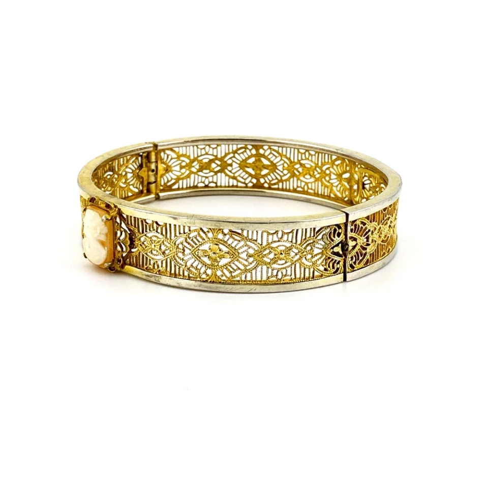Profile view of Antique gold filled filigree clamper bracelet with hand carved shell cameo and hidden clasp