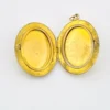 opened interior of Edwardian gold filled Binder Bros oval locket with hand carved shell cameo and engraved center panel