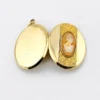 opened Edwardian gold filled Binder Bros oval locket with hand carved shell cameo and engraved center panel