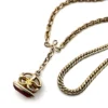 Gold filled repurposed pocket watch chain necklace with pink jeweled fob charm and mixed chain links