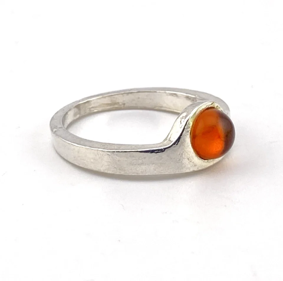 Vintage Modernist sterling silver ring with a round honey colored Baltic amber cabochon.