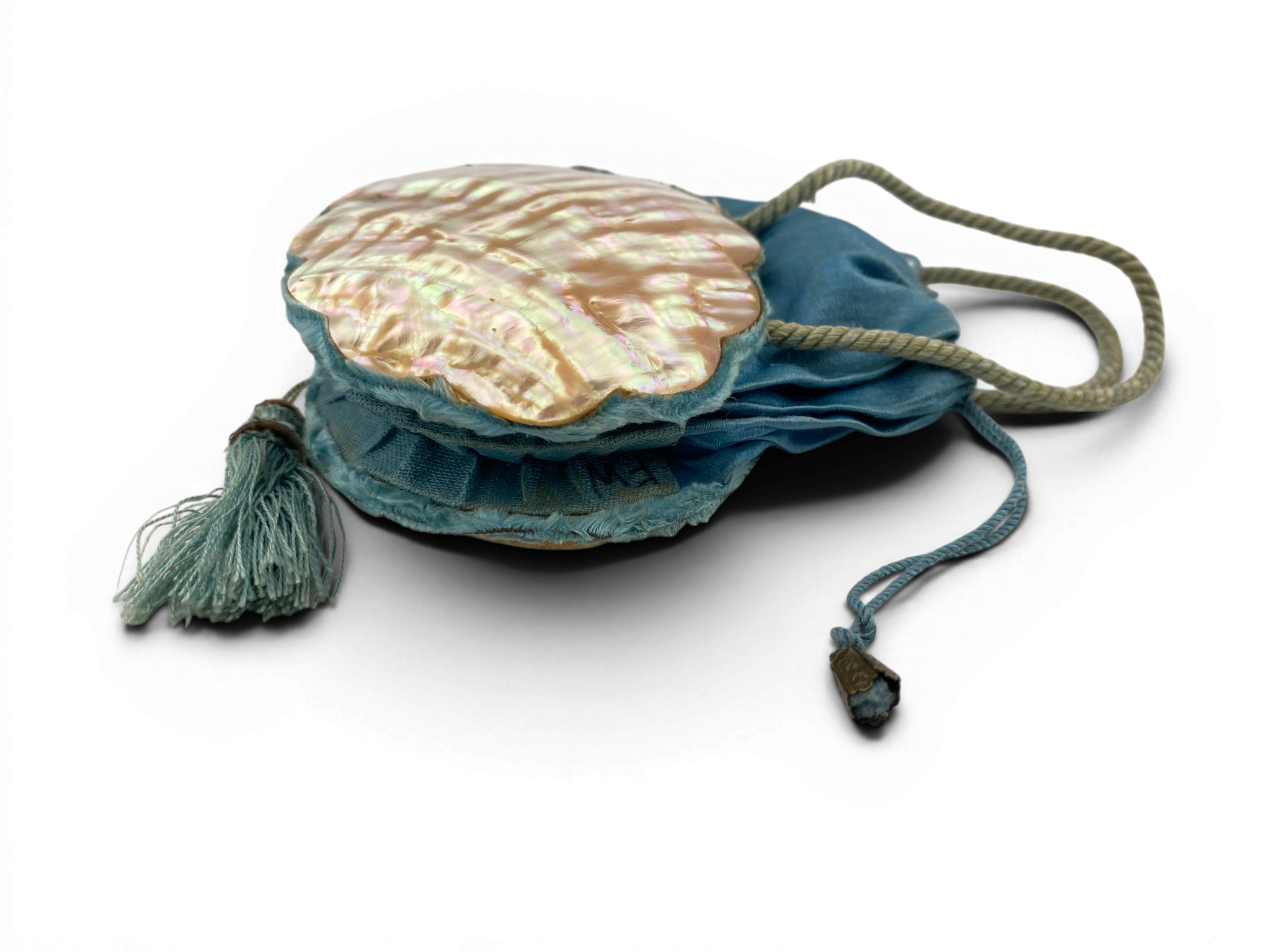 Antique Art Nouveau era mother-of-pearl and blue silk necessaire purse with scalloped shell panels, rope handles, and tassel.