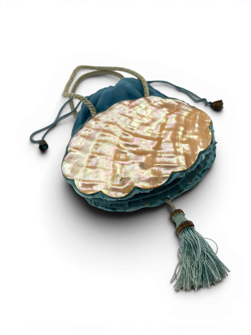Antique Art Nouveau era mother-of-pearl and blue silk necessaire purse with scalloped shell panels, rope handles, and tassel.