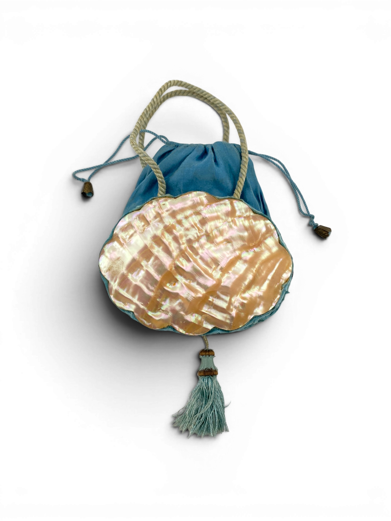 Antique Art Nouveau era mother-of-pearl and blue silk necessaire purse with scalloped shell panels, rope handles, and tassel.