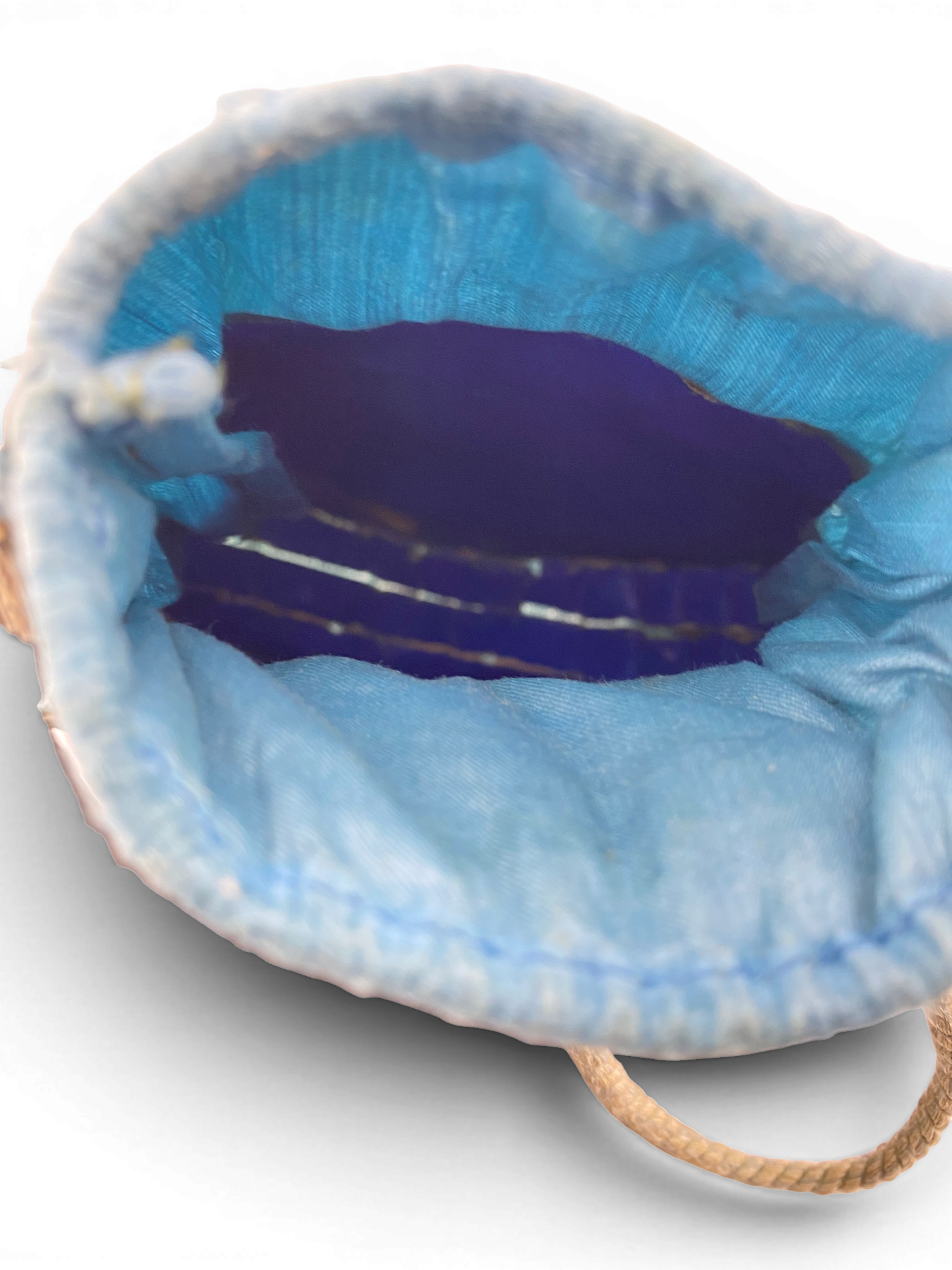Antique Art Nouveau era mother-of-pearl and blue silk necessaire purse with scalloped shell panels, rope handles, and tassel.