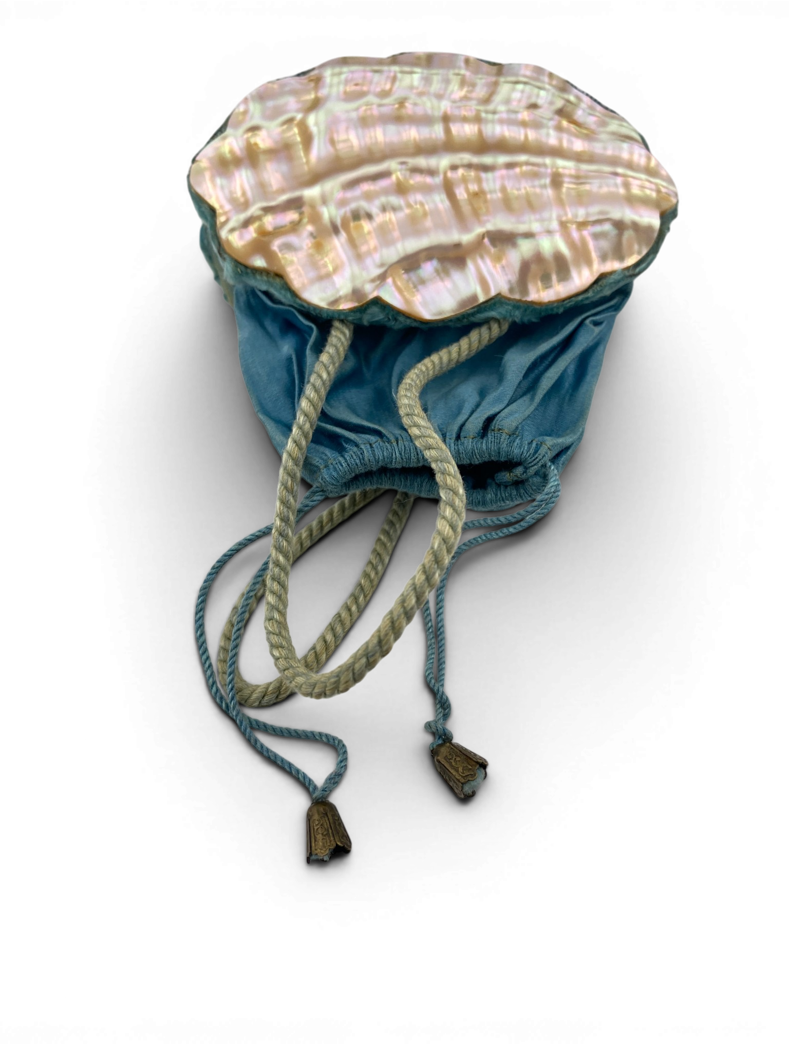 Antique Art Nouveau era mother-of-pearl and blue silk necessaire purse with scalloped shell panels, rope handles, and tassel.