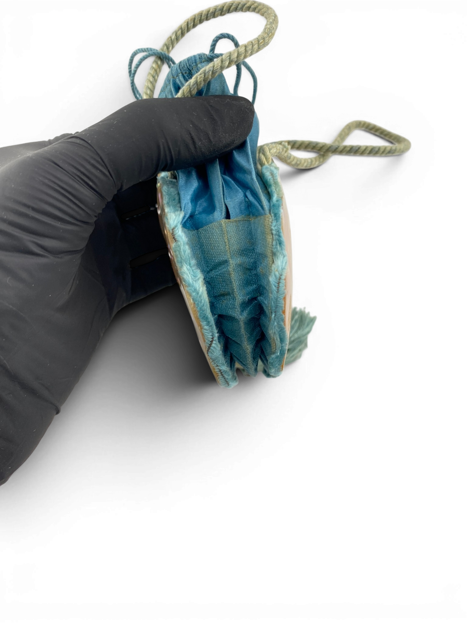Antique Art Nouveau era mother-of-pearl and blue silk necessaire purse with scalloped shell panels, rope handles, and tassel.