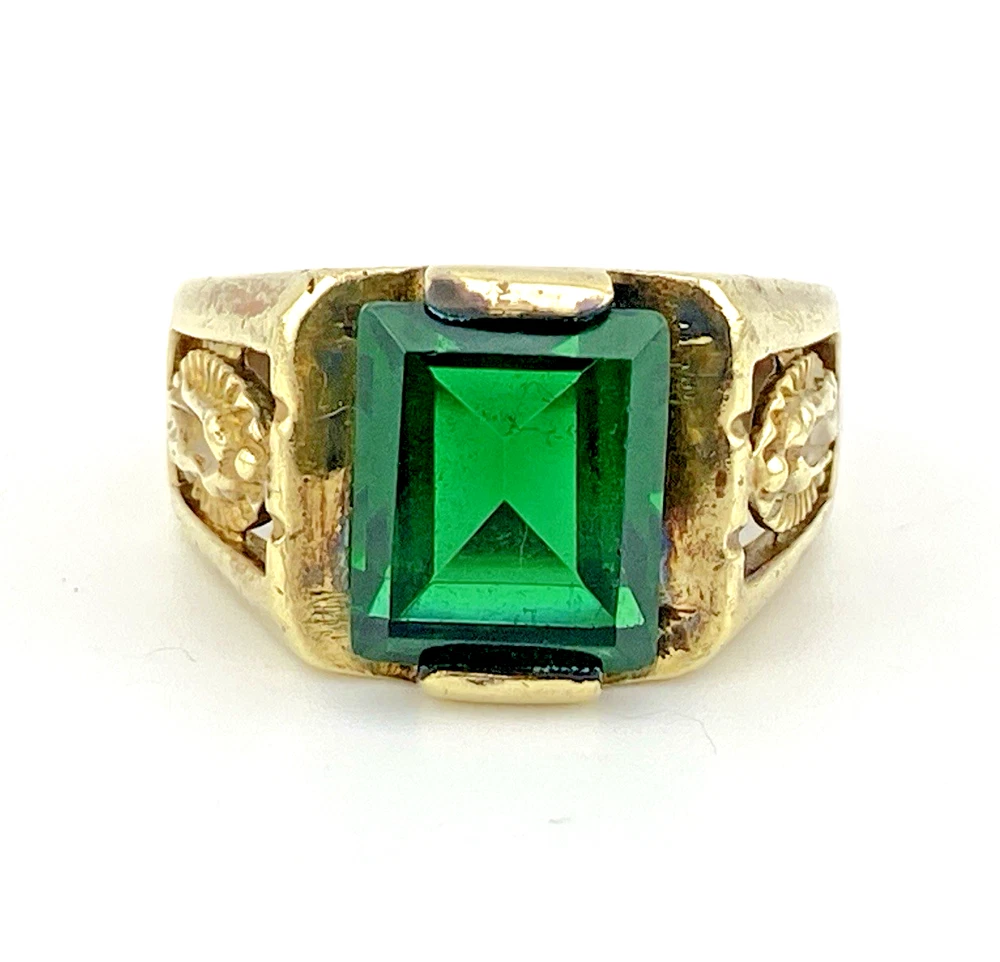 Vintage Mexican biker brass ring with green faceted glass stone and Our Lady of Guadalupe shoulders