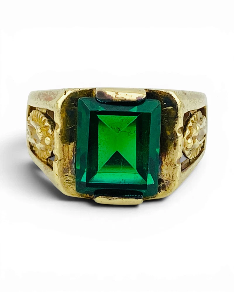 Vintage Mexican biker brass ring with green faceted glass stone and Our Lady of Guadalupe shoulders
