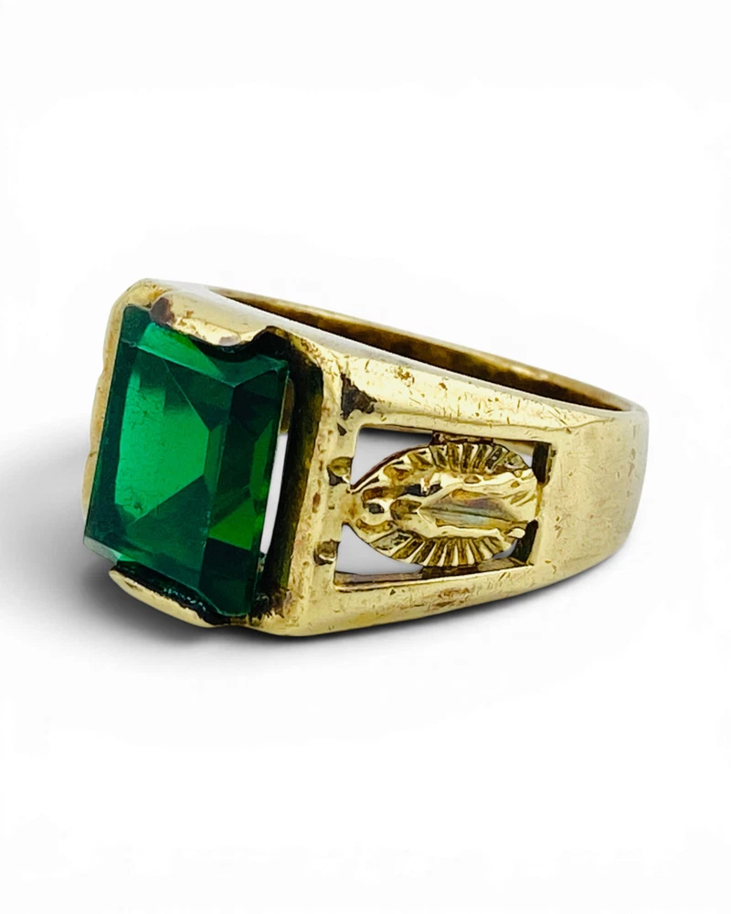 Vintage Mexican biker brass ring with green faceted glass stone and Our Lady of Guadalupe shoulders