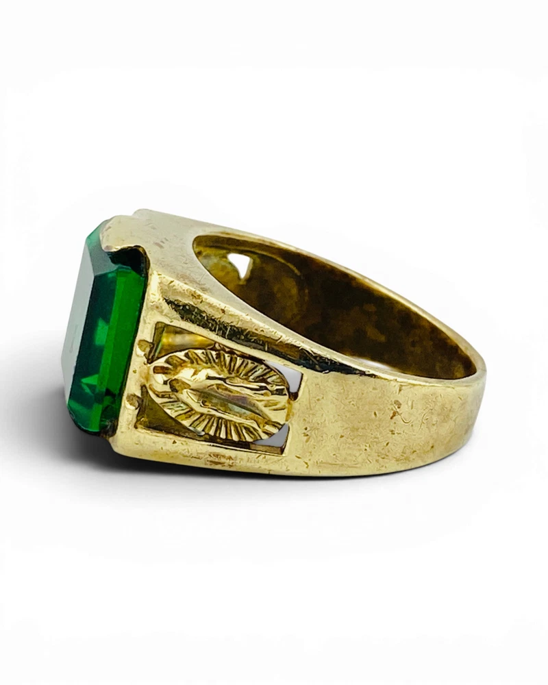 Vintage Mexican biker brass ring with green faceted glass stone and Our Lady of Guadalupe shoulders