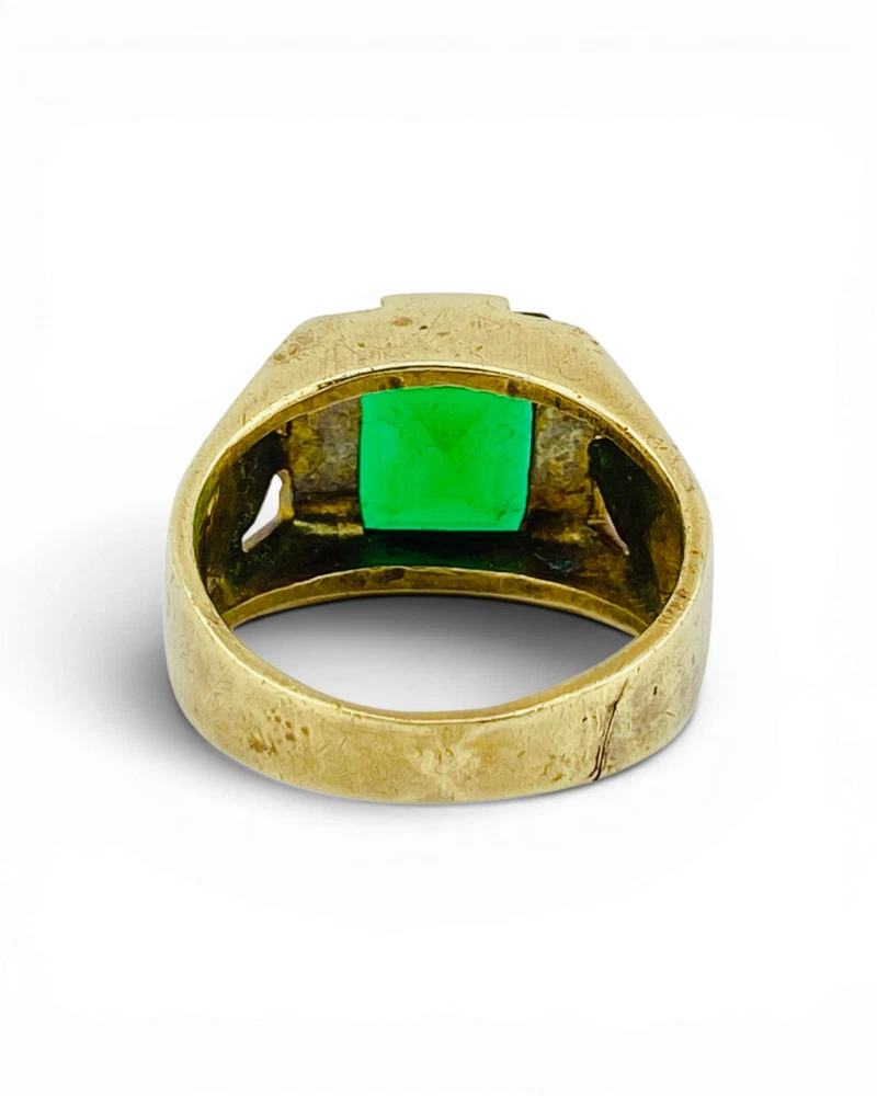 Vintage Mexican biker brass ring with green faceted glass stone and Our Lady of Guadalupe shoulders