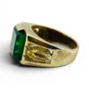 Vintage Mexican biker brass ring with green faceted glass stone and Our Lady of Guadalupe shoulders