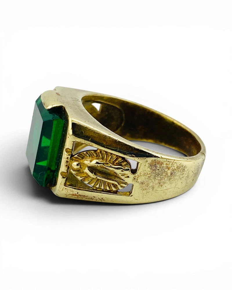Vintage Mexican biker brass ring with green faceted glass stone and Our Lady of Guadalupe shoulders
