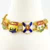 Vintage Canada souvenir bracelet with colorful enameled provincial shield links and gold plated finish