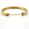 Vintage Carl Art 14k gold filled twisted rope hinged bangle bracelet with oval hollow form