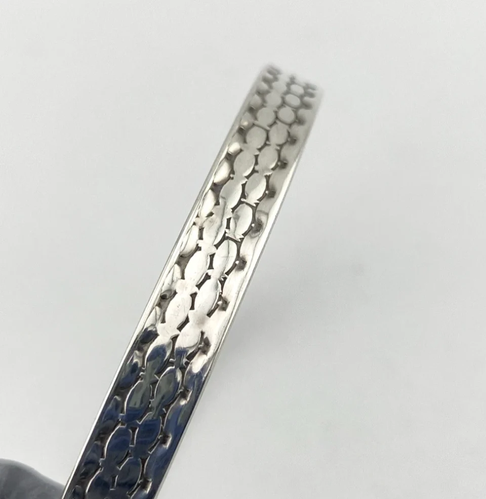 Vintage Beau Sterling silver bangle bracelet with stamped geometric pattern.