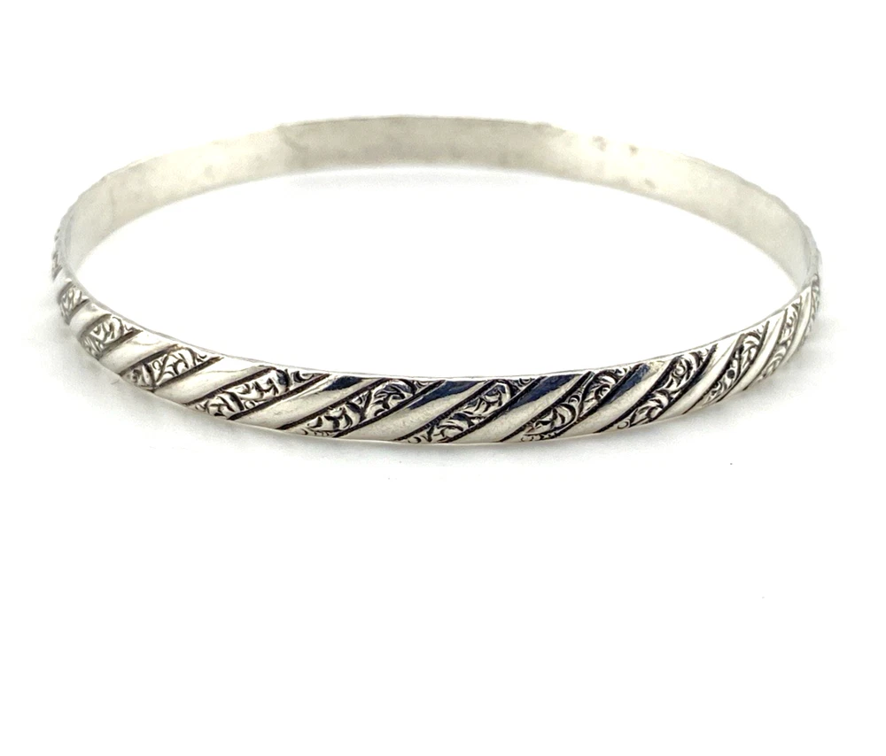 Vintage Danecraft sterling silver bangle bracelet with raised spiral rope design and carved scroll details.