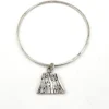 Hand wrought sterling silver studio bangle bracelet with trapezoid charm and organic stamped texture.
