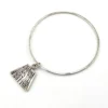 Hand wrought sterling silver studio bangle bracelet with trapezoid charm and organic stamped texture.