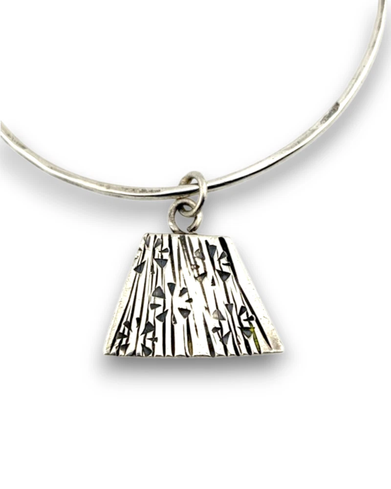 Hand wrought sterling silver studio bangle bracelet with trapezoid charm and organic stamped texture.