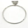 Hand wrought sterling silver studio bangle bracelet with trapezoid charm and organic stamped texture.