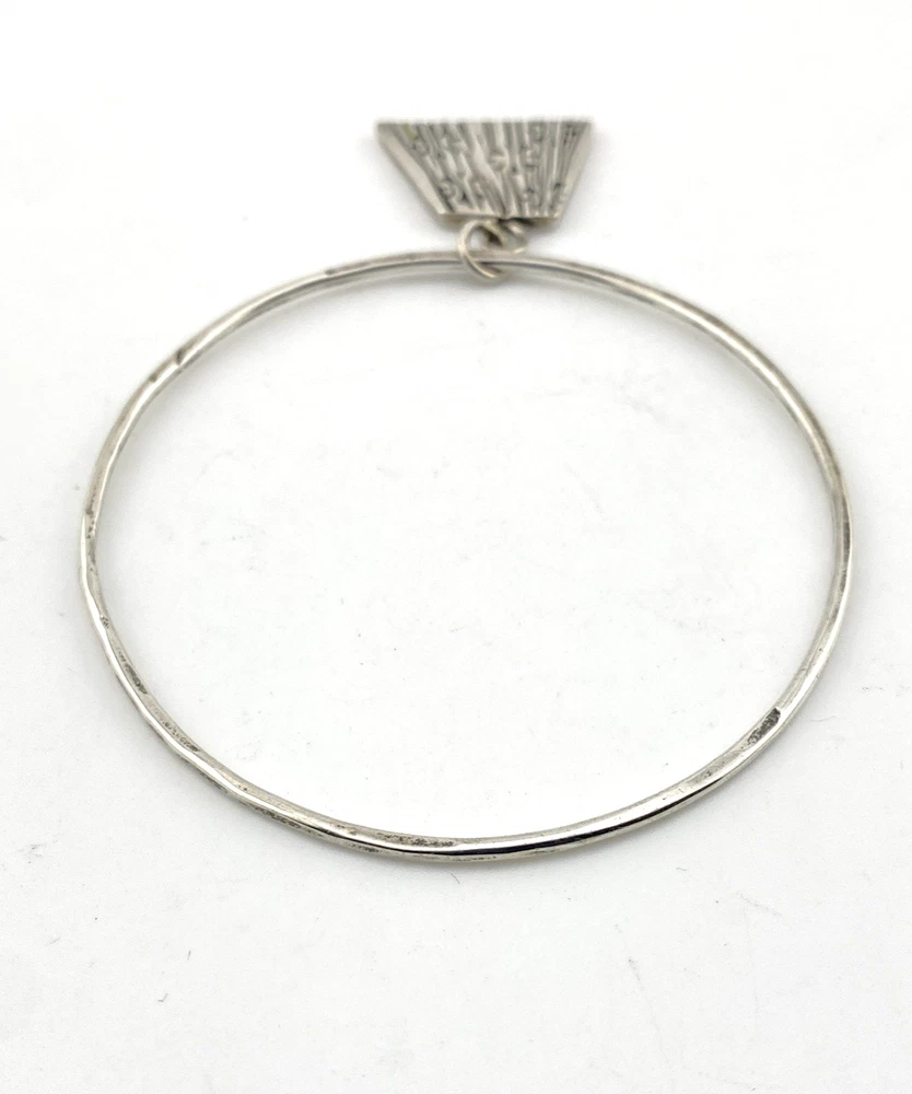 Hand wrought sterling silver studio bangle bracelet with trapezoid charm and organic stamped texture.