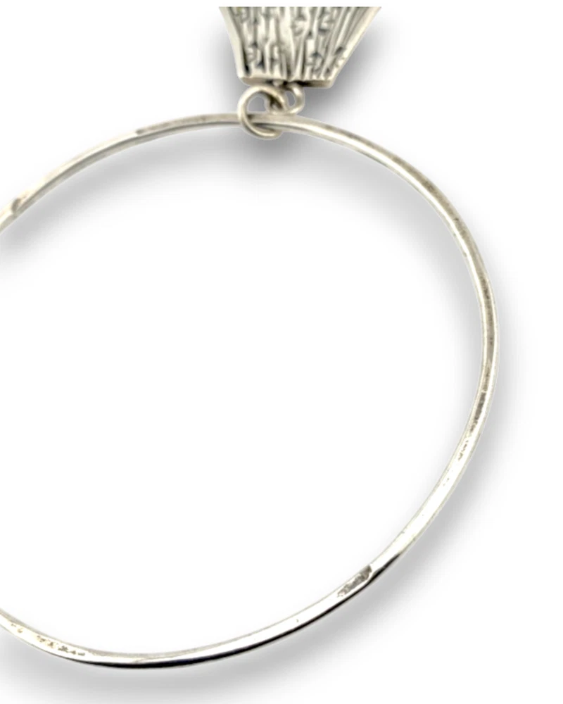 Hand wrought sterling silver studio bangle bracelet with trapezoid charm and organic stamped texture.