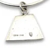 Hand wrought sterling silver studio bangle bracelet with trapezoid charm and organic stamped texture.