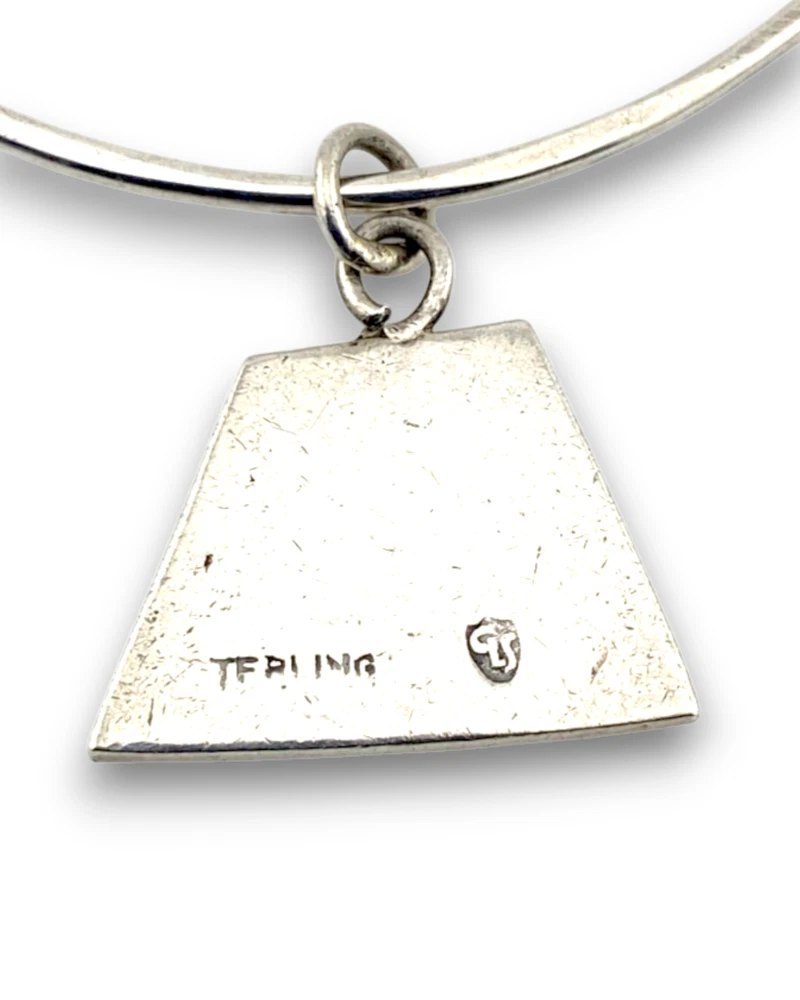 Hand wrought sterling silver studio bangle bracelet with trapezoid charm and organic stamped texture.