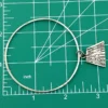 Hand wrought sterling silver studio bangle bracelet with trapezoid charm and organic stamped texture.